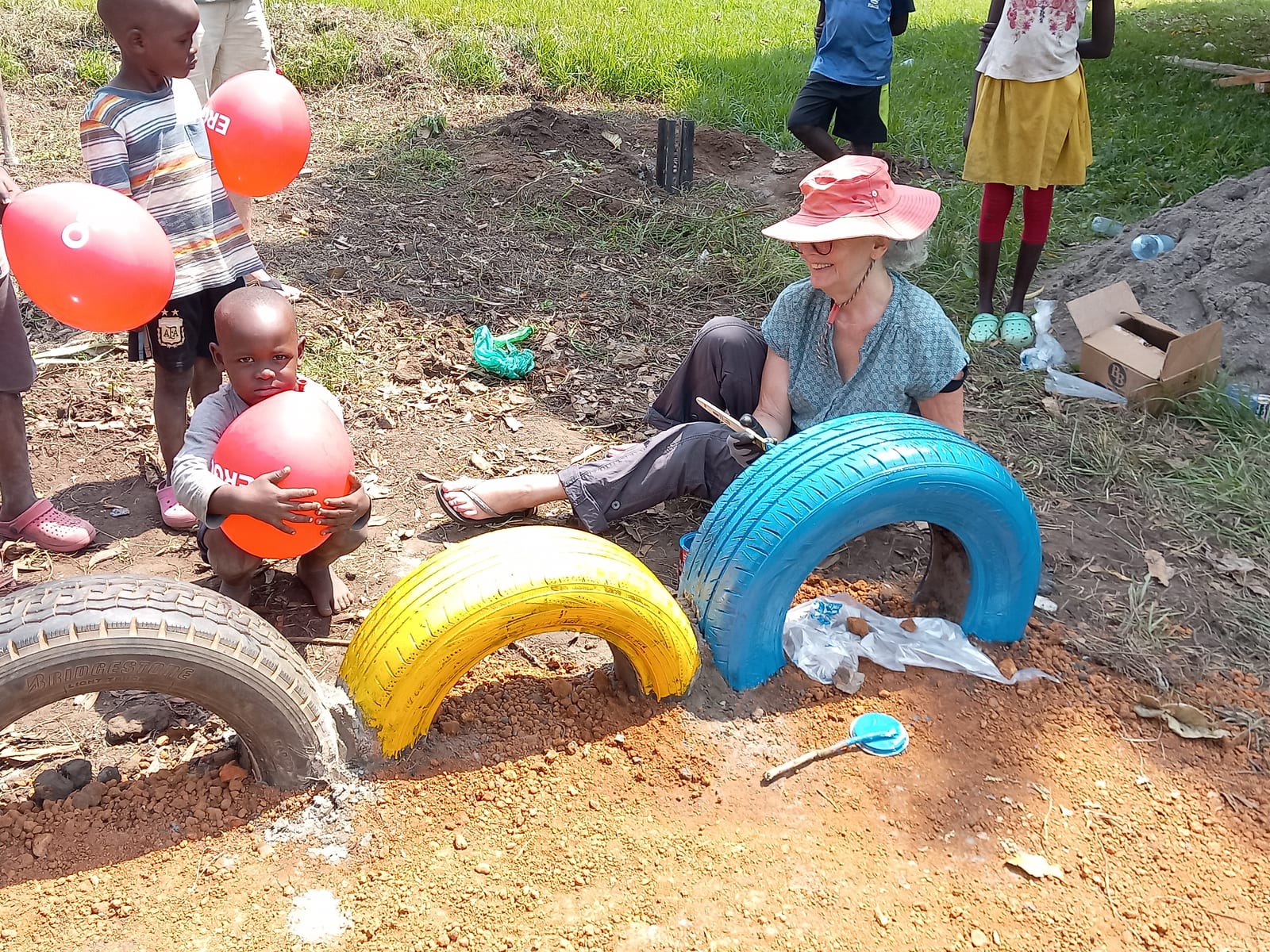 The old tyres are painted together with the children